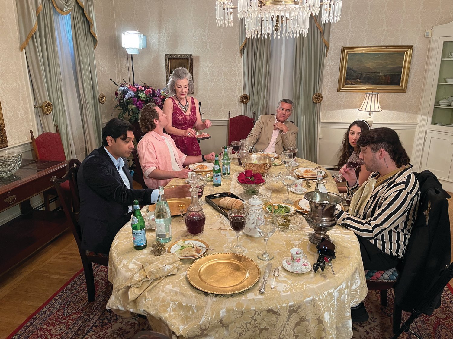 ON SET: Actors in “Poor Paul” film a scene in Sprague Mansion’s dining room on Friday. Pictured, from left, are Abhi Sinda, Nick Pasqual, Sissy O’Hara, Stephen O’Neil Martin, Courtney Danforth and Adam Carbone.